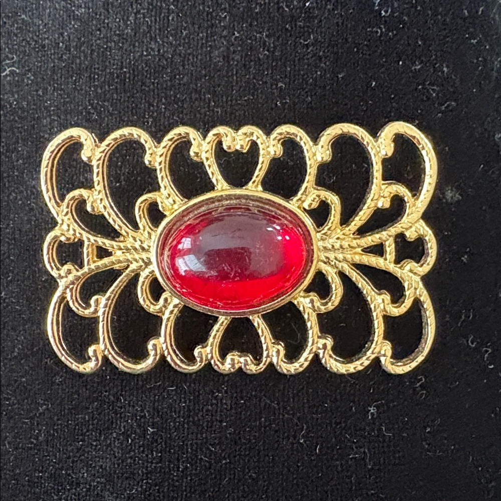 Elegant Gold Brooch with Red Gem